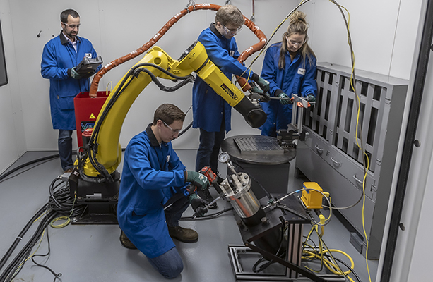 Professor Joe Stanzione and researchers working in cold spray lab