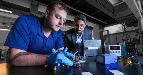 Mechanical engineering major Kyle Knowles works in the lab with Amin Nozari, Ph.D.