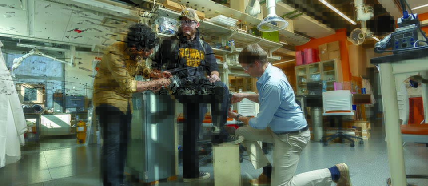 Vaibhavsingh Varma, Ph.D. candidate; Zachary Roberts, undergraduate student; and Mitja Trkov, Ph.D., assistant  professor, are testing a wearable exoskeleton device.