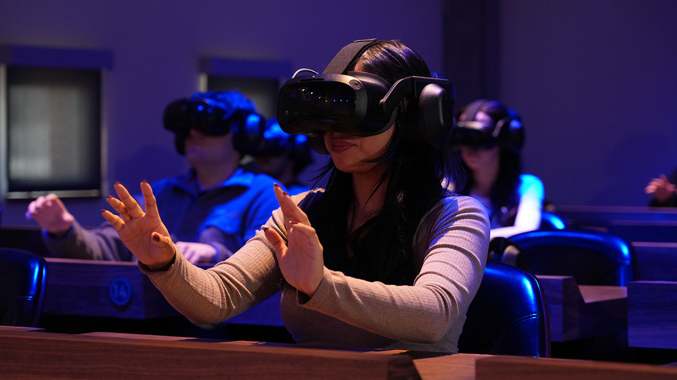 Student wearing a VR headset in the Dreamscape Learn Center classroom.