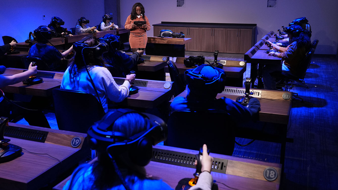 Professor leading students in VR lesson.