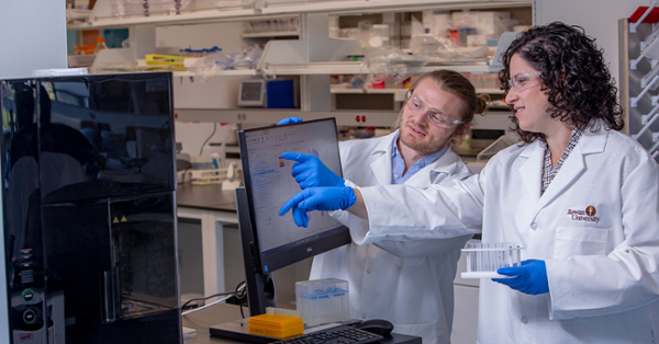 Rachel Riley, Ph.D., (right) and Samuel Hofbauer, an M.D./Ph.D. student, are developing nanoparticles that target specialized cells in the placenta.